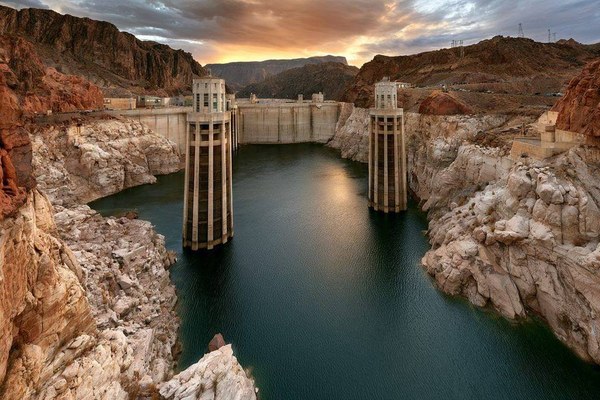 A hydroelectric dam with visibly low water behind it
