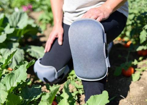 Close-up of a thick gel knee pad strapped on for ground-level garden work
