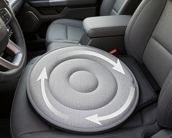 A round gray swivel seat cushion with rotation arrows sitting on a truck's front seat
