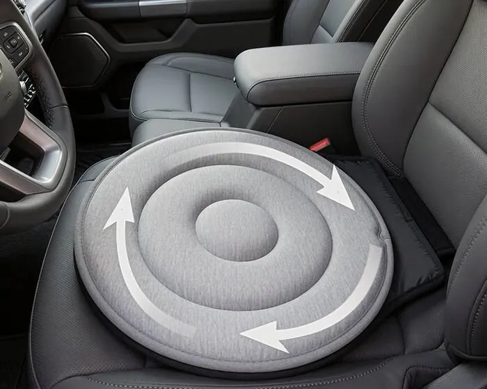 A round gray swivel seat cushion with rotation arrows sitting on a truck's front seat