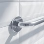 Chrome grab bar mounted on white tile