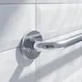Chrome grab bar mounted on white tile